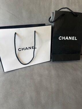 Chanel 2 logo matte paper gift bag + bonus eye makeup instruction booklet.
